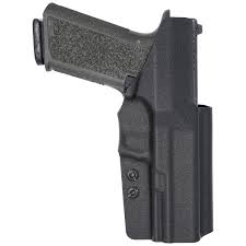 Subcompact pistol in a concealed carry holster showing slim profile and minimal printing for everyday carry